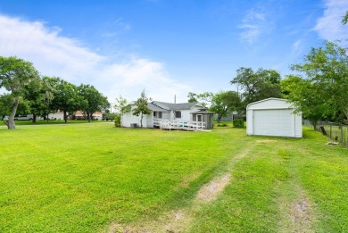 This charming three-bedroom, one-bathroom home sits proudly on a
