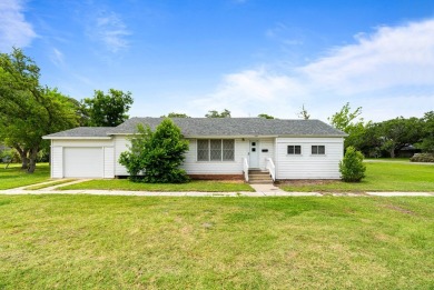 This charming three-bedroom, one-bathroom home sits proudly on a