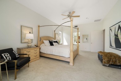 The beautifully relandscaped front yard with faux grass, exotic