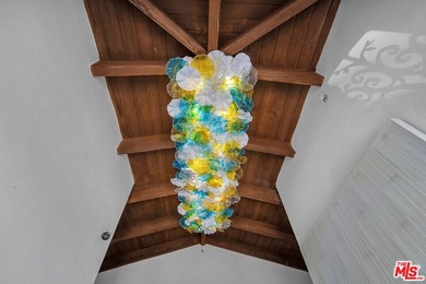 Perched atop a secluded, gated street off Benedict Canyon Drive