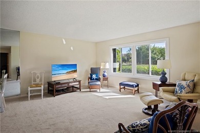 Enjoy the ease of Florida living in this first floor, end unit