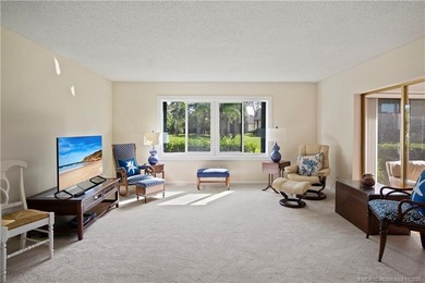 Enjoy the ease of Florida living in this first floor, end unit