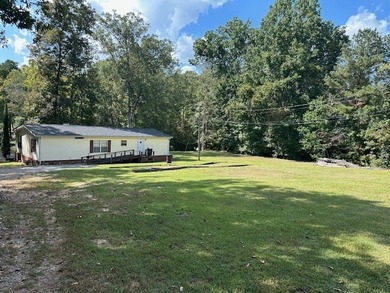 Come enjoy this quiet setting with access to Lake Sinclair. This