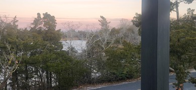 This lake-view corner, new-construction home is situated on a