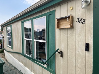 Manufactured 3-2 with an open living space, front deck, handicap