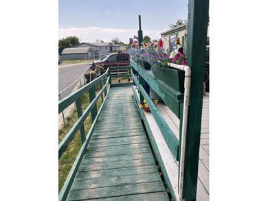 Manufactured 3-2 with an open living space, front deck, handicap