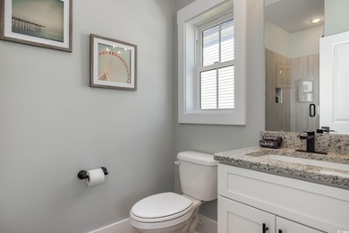 Just a quarter mile from the beach, this stunning 5-bedroom, 5