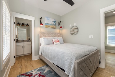 Just a quarter mile from the beach, this stunning 5-bedroom, 5