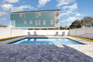 Just a quarter mile from the beach, this stunning 5-bedroom, 5