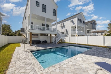 Just a quarter mile from the beach, this stunning 5-bedroom, 5