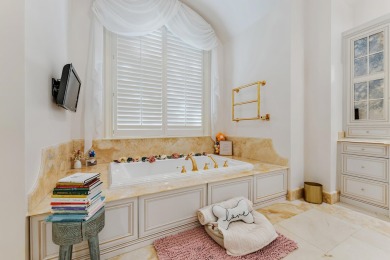 Enjoy the elegance of this custom, over 9,000 square ft estate