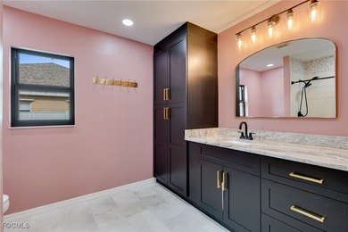 Welcome to a truly rare Cape Coral waterfront estate located on