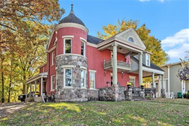 The red stately VICTORIAN offers appealing bay windows, a