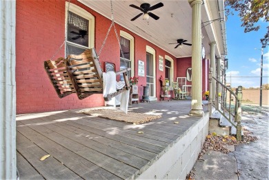 The red stately VICTORIAN offers appealing bay windows, a