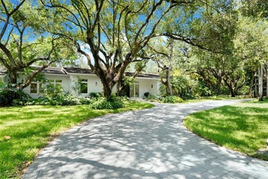 Set on a rare, oversized 56,192 SF lot in one of Coral Gables'