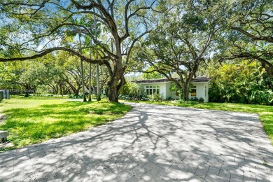 Set on a rare, oversized 56,192 SF lot in one of Coral Gables'