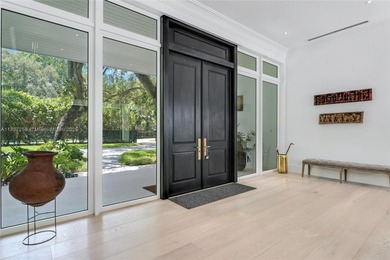 Set on a rare, oversized 56,192 SF lot in one of Coral Gables'