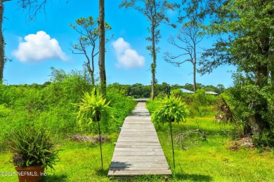 Embrace upscale, waterside living in this stunning two-story, 5