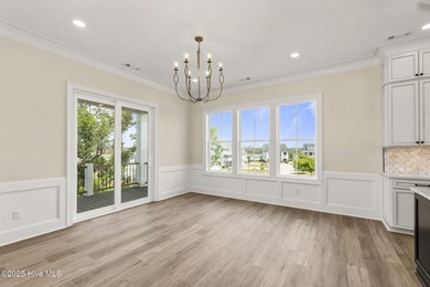 This exceptional new construction in Mariners Pointe blends