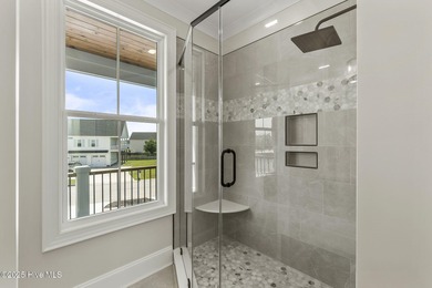 This exceptional new construction in Mariners Pointe blends