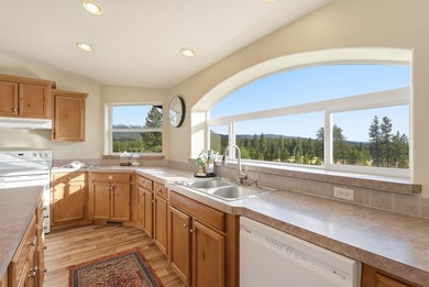 Tucked on nearly five acres in Chattaroy, this 2,800 sq ft home