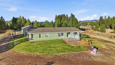 Tucked on nearly five acres in Chattaroy, this 2,800 sq ft home