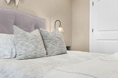 Step into low-maintenance living where the lake is your backdrop