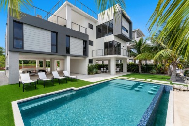 A modern sanctuary on the water, this newly built Key Largo