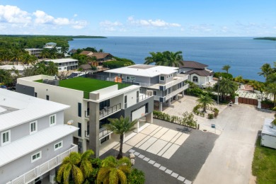 A modern sanctuary on the water, this newly built Key Largo