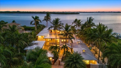 Nestled behind custom gates on nearly 0.83 acres of lushly