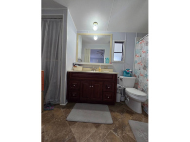 Welcome to this beautifully maintained 1990 double-wide