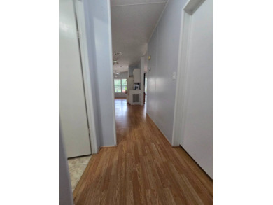 Welcome to this beautifully maintained 1990 double-wide