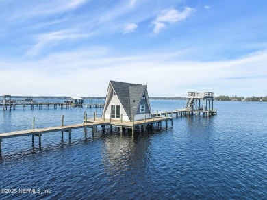 Look at this gorgeous waterfront home! This mid-century, custom