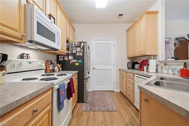 Second story condo with elevator. Covered balcony.  Large open