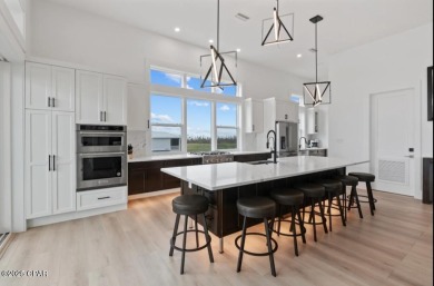 A SHOWSTOPPER of a home! Located in Secluded Dunes subd. This