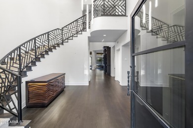 Welcome to 10163 E. Hualapai Drive, a timeless estate nestled in