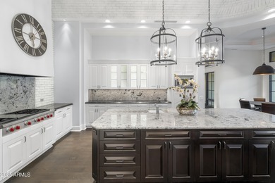 Welcome to 10163 E. Hualapai Drive, a timeless estate nestled in