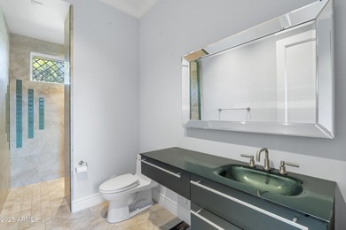 Welcome to 10163 E. Hualapai Drive, a timeless estate nestled in