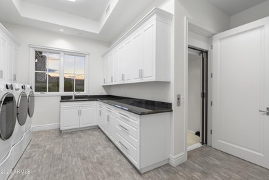 Welcome to 10163 E. Hualapai Drive, a timeless estate nestled in