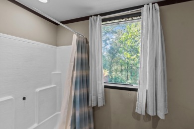 Escape to your own private retreat on over an acre of wooded