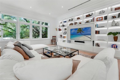Set on a rare, oversized 56,192 SF lot in one of Coral Gables'