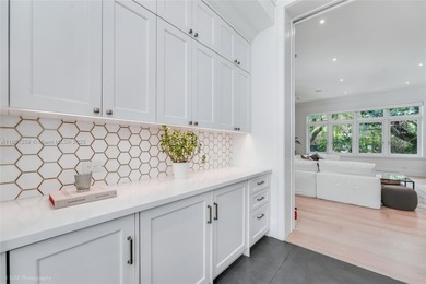 Set on a rare, oversized 56,192 SF lot in one of Coral Gables'