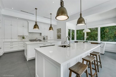 Set on a rare, oversized 56,192 SF lot in one of Coral Gables'