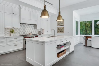 Set on a rare, oversized 56,192 SF lot in one of Coral Gables'