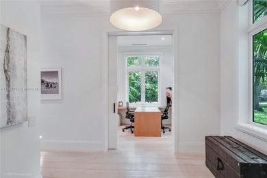 Set on a rare, oversized 56,192 SF lot in one of Coral Gables'