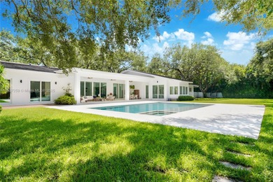 Set on a rare, oversized 56,192 SF lot in one of Coral Gables'