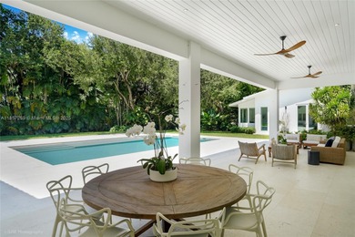 Set on a rare, oversized 56,192 SF lot in one of Coral Gables'