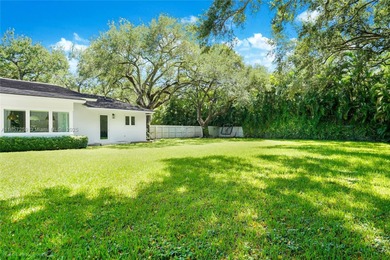 Set on a rare, oversized 56,192 SF lot in one of Coral Gables'