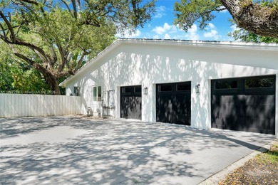 Set on a rare, oversized 56,192 SF lot in one of Coral Gables'