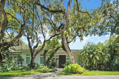 Set on a rare, oversized 56,192 SF lot in one of Coral Gables'